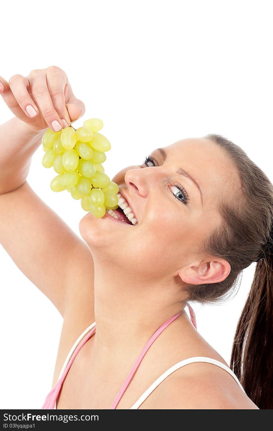 Young woman eating grapes