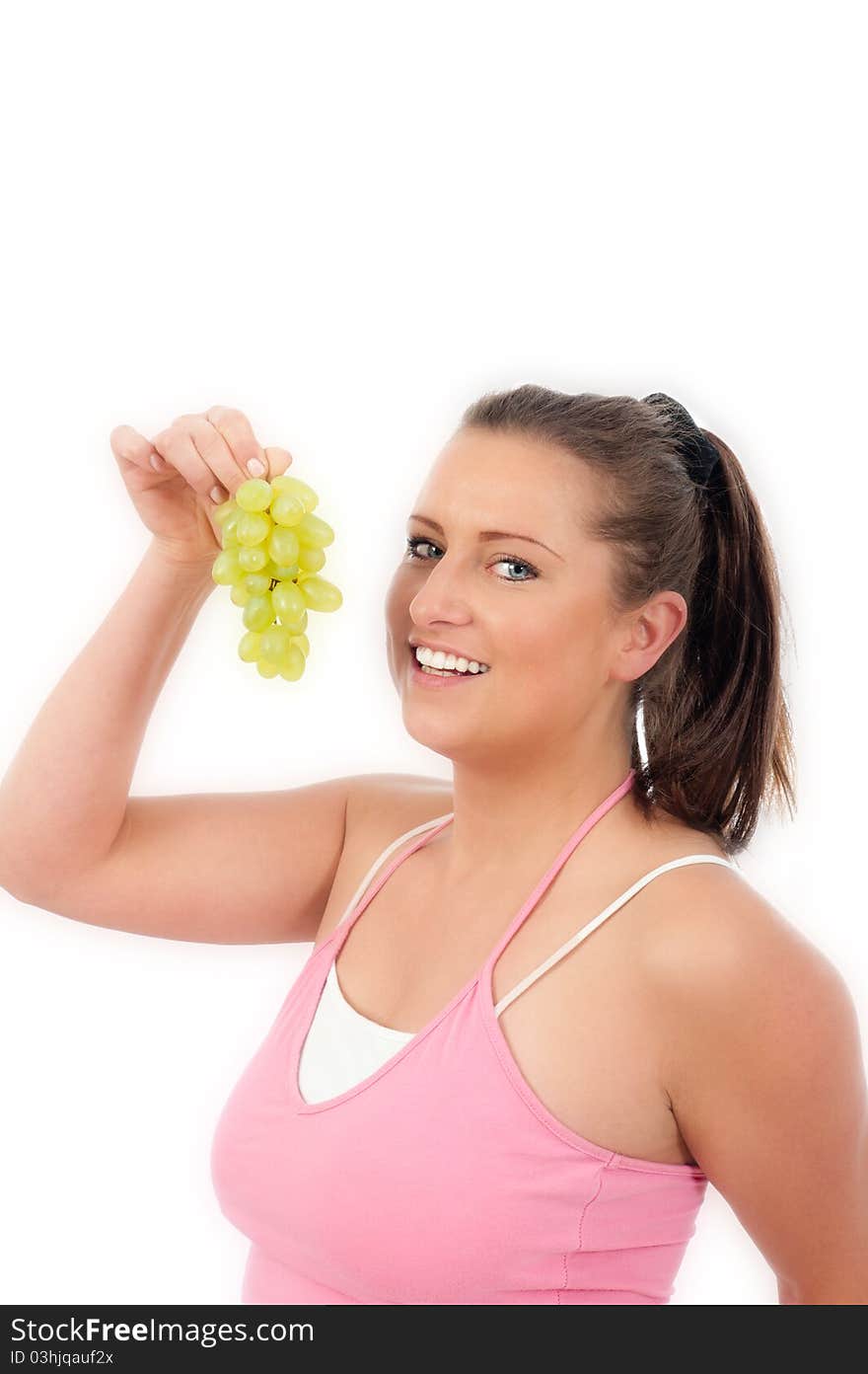 Young woman eating grapes