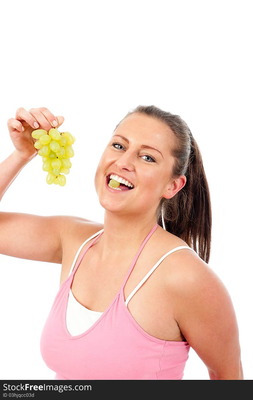 Young woman eating grapes