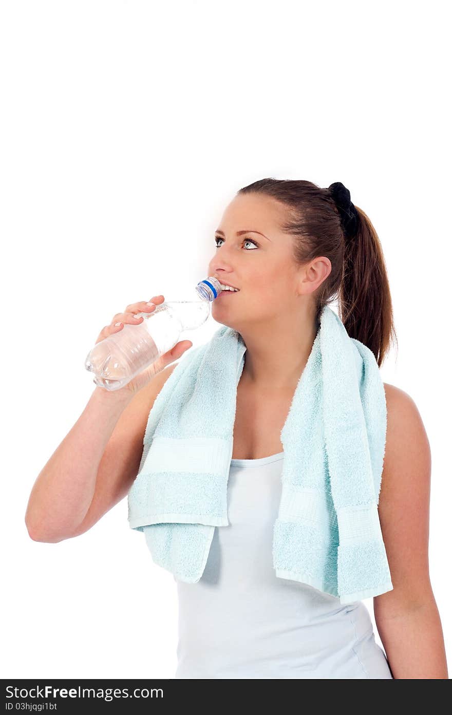 Young woman drinking water after exercise