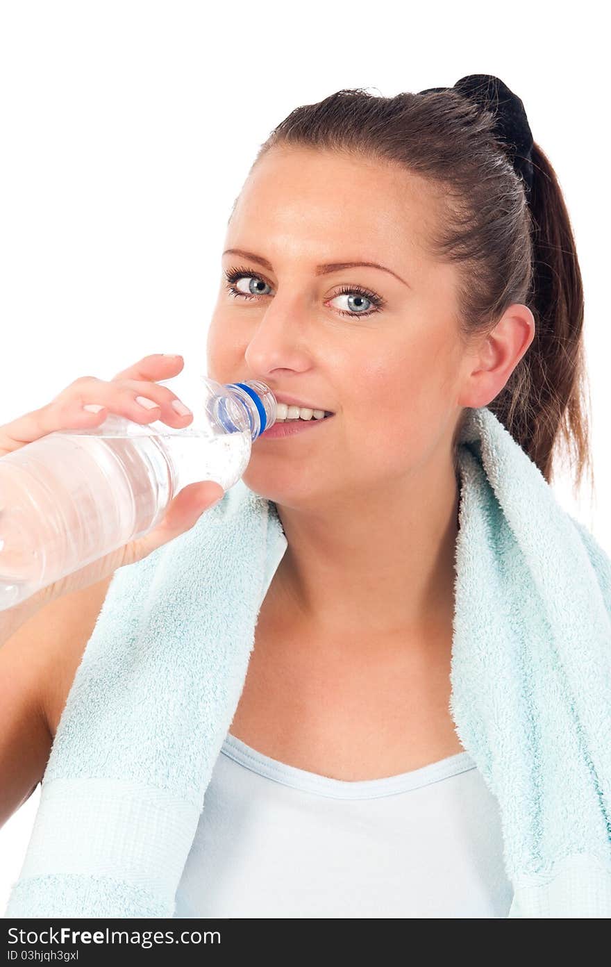 Young woman drinking water after exercise