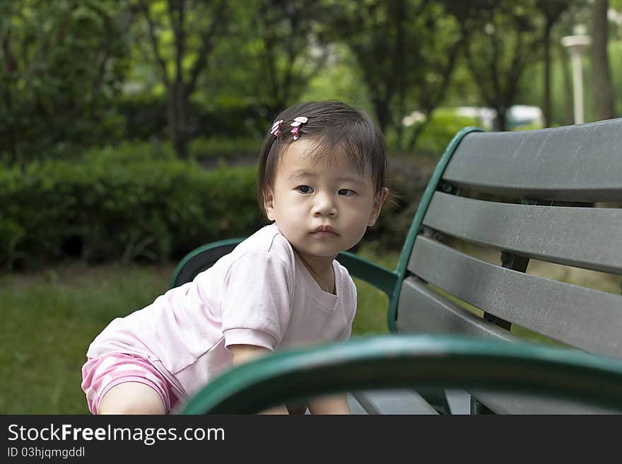 A little girl is climbing stools. A little girl is climbing stools