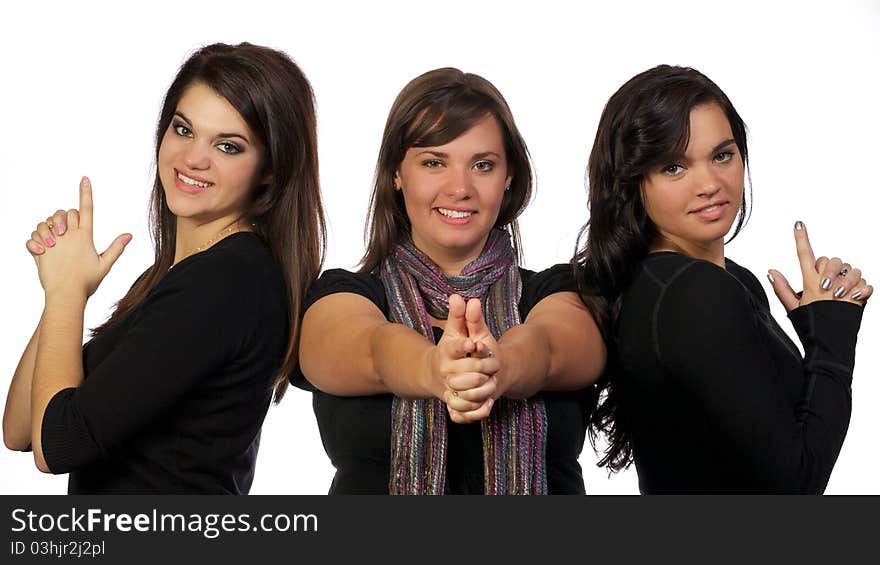 Young adult ladies posing as though they have guns in their hands. Young adult ladies posing as though they have guns in their hands.