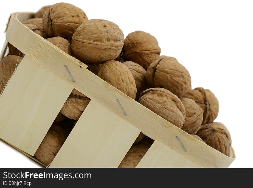 Basket with the walnuts against the white background