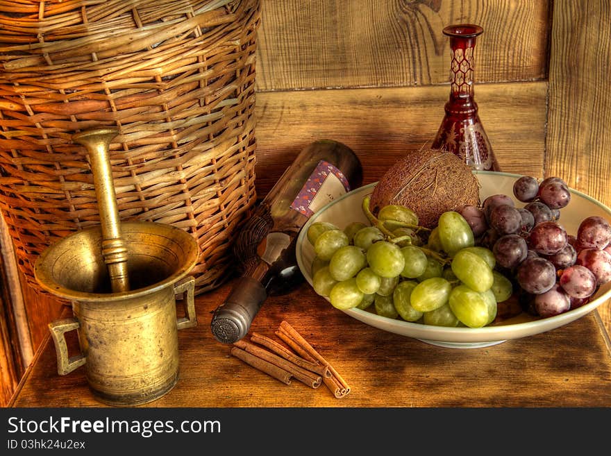 wine and grapes on wooden background