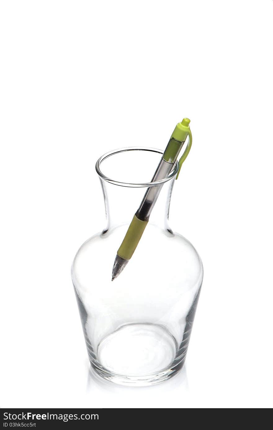 Fragile glass transparent vessel with green pen isolated on white