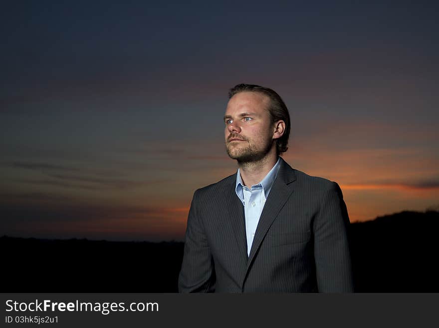 Man in suit standing in sunset. Man in suit standing in sunset