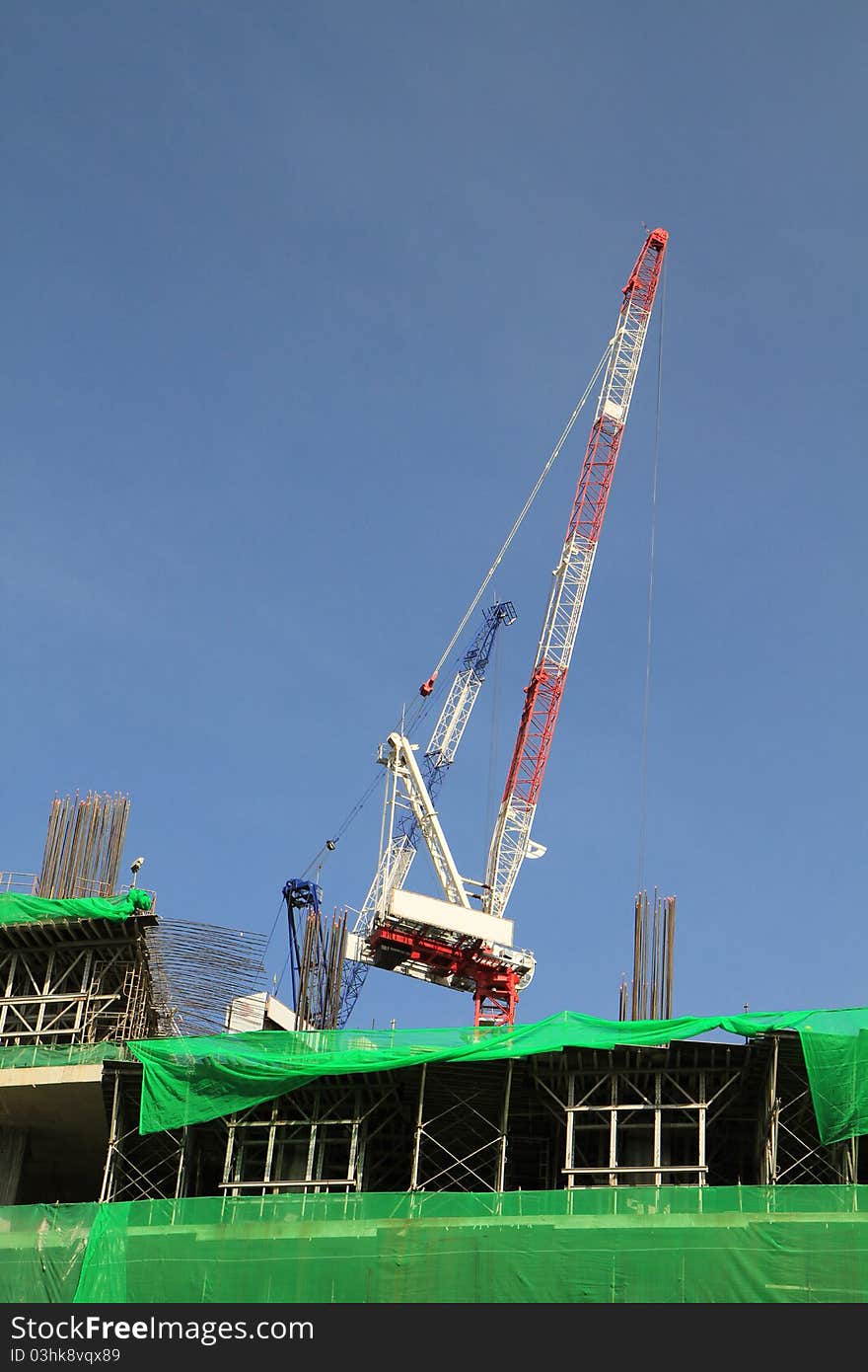 Crane and building construction on blue background