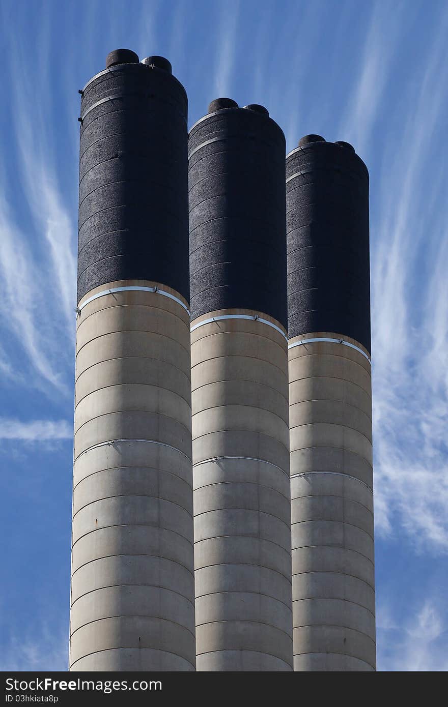 Row of concrete industrial chimnies