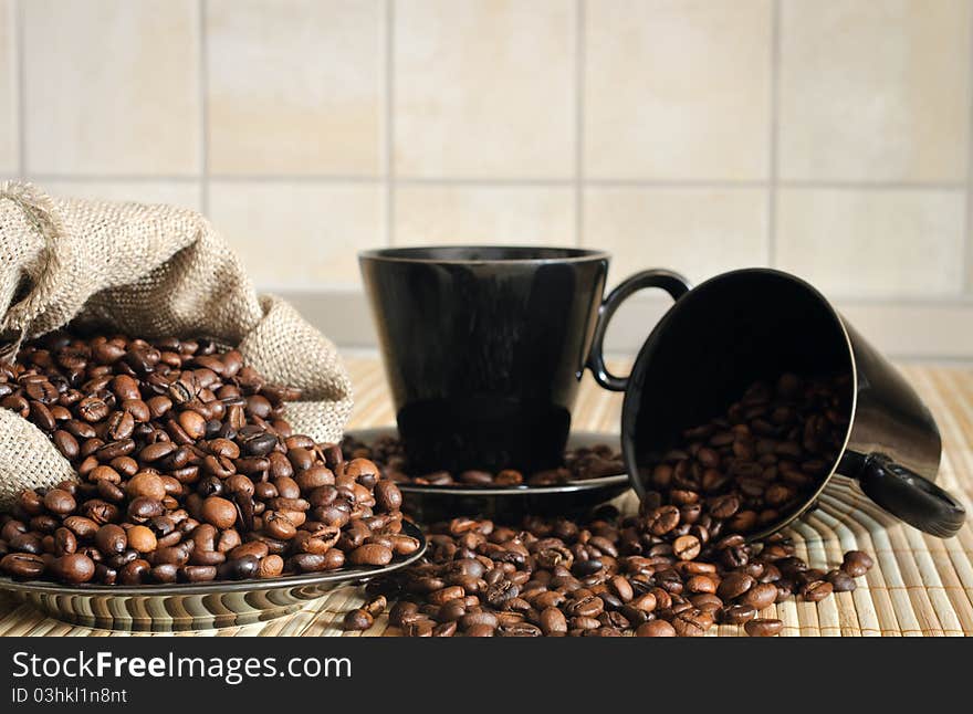 Coffee beans with cups and sack