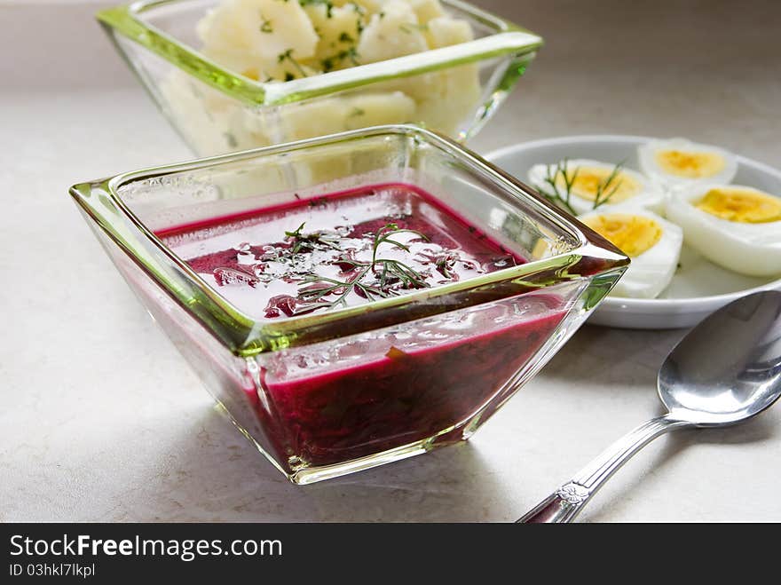 Borscht with beet and eggs, served with hot potatoes