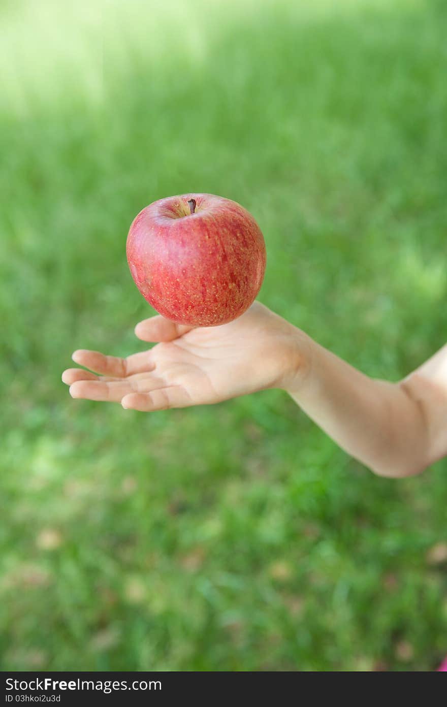 An aerial apple and a hand. An aerial apple and a hand