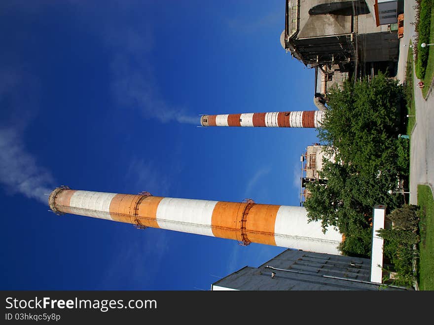 Two of the most high exhaust pipes at a cement plant. Western Russia. Two of the most high exhaust pipes at a cement plant. Western Russia