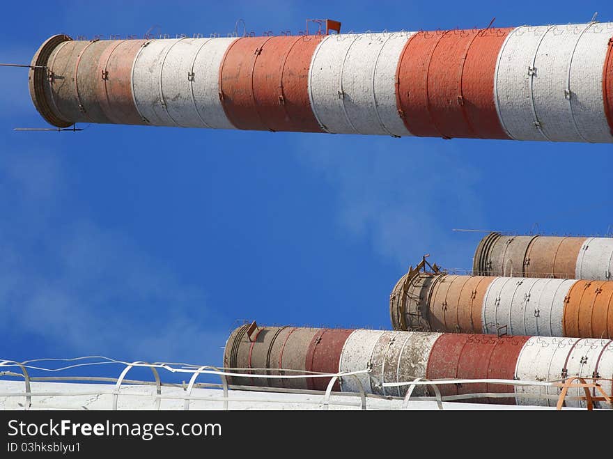 Four of the most high exhaust pipes at a cement plant. Western Russia. Four of the most high exhaust pipes at a cement plant. Western Russia