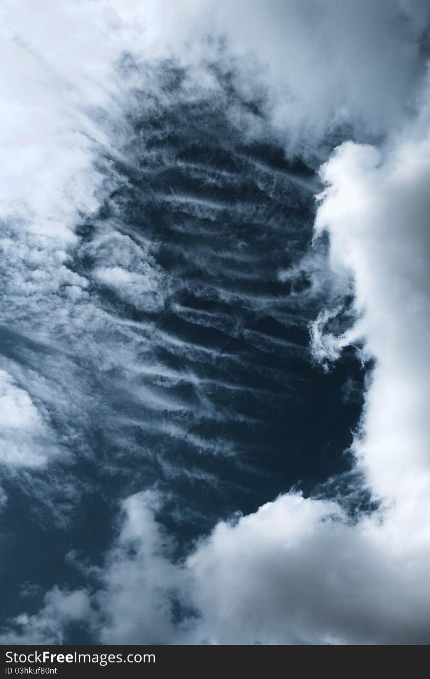 HDR-composite of 3 images showing nice parallel clouds behind some stratus clouds.