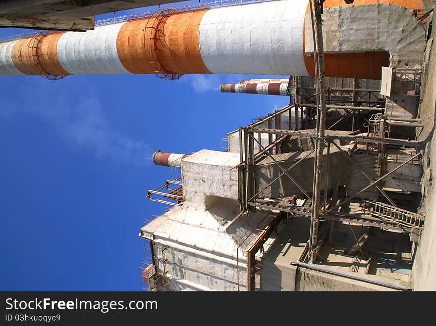 High brick chimneys at a cement plant. Western Russia. High brick chimneys at a cement plant. Western Russia