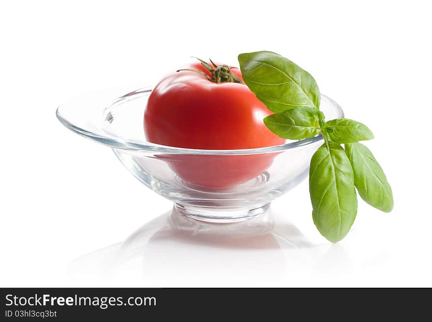 Fresh tomato with green leaf isolated on white background