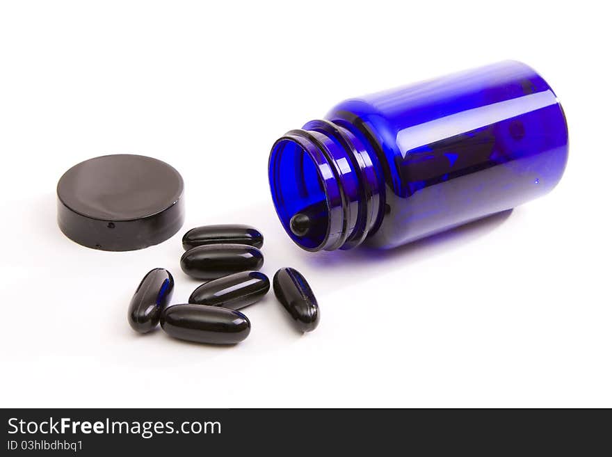 Blue bottle of prescribed pills on white background