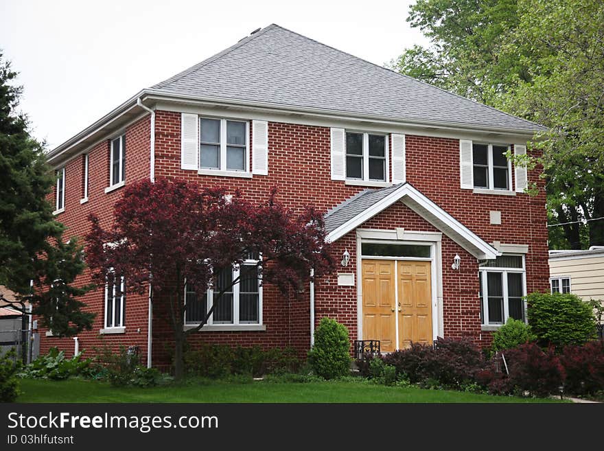 Image of a single family home with many windows and beautiful landscaping. Image of a single family home with many windows and beautiful landscaping.