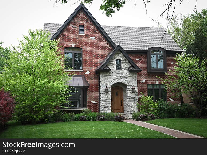 Image of a single family home with many windows and beautiful landscaping. Image of a single family home with many windows and beautiful landscaping.