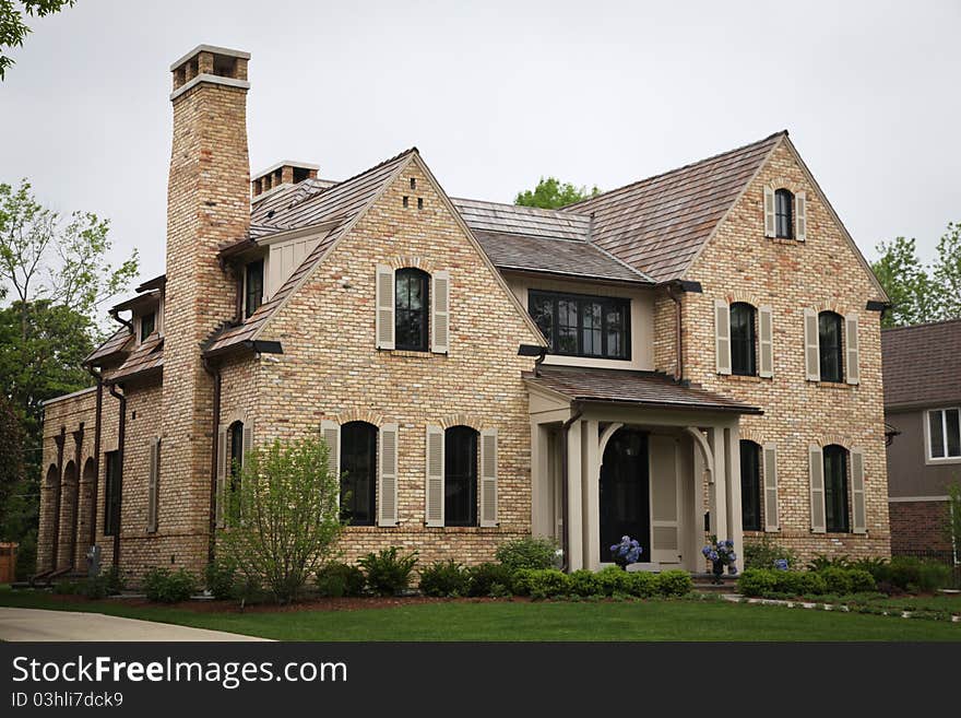 Image of a single family home with many windows and beautiful landscaping. Image of a single family home with many windows and beautiful landscaping.