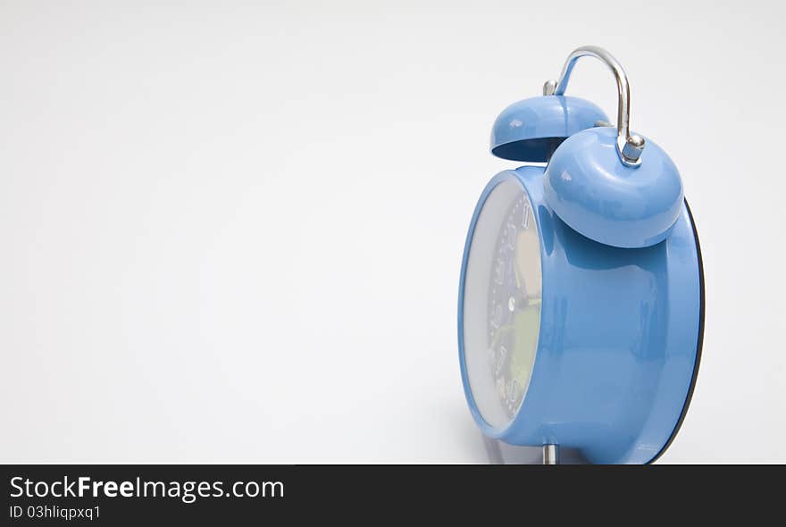 Blue alarm clock on a white background. Blue alarm clock on a white background