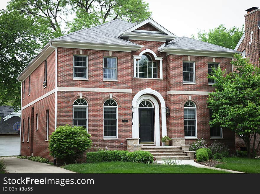 Image of a single family home with many windows and beautiful landscaping. Image of a single family home with many windows and beautiful landscaping.