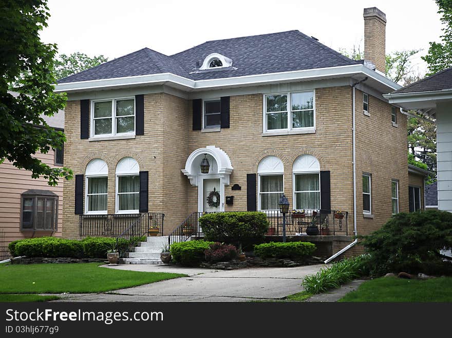 Image of a single family home with many windows and beautiful landscaping. Image of a single family home with many windows and beautiful landscaping.