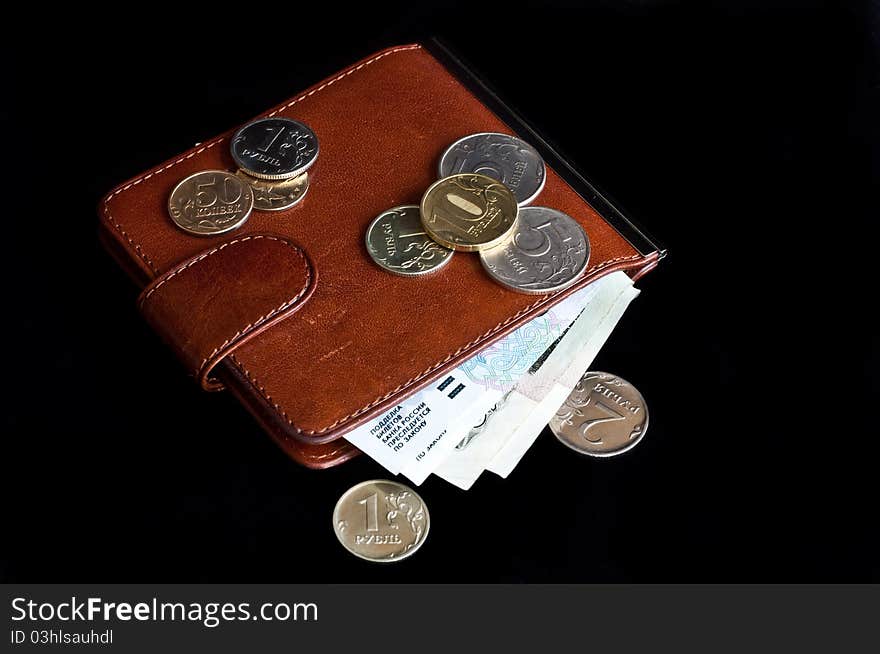 Coins and notes in a brown Moneyclip