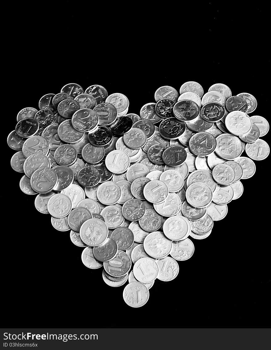 Pile of coins in the form of heart