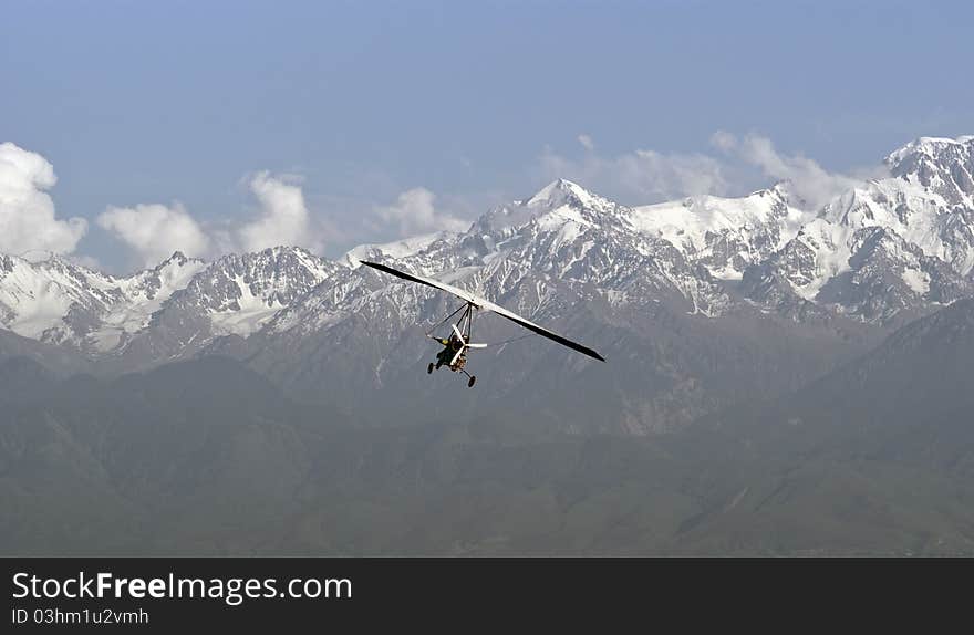 Powered hang glider mountains in the background.