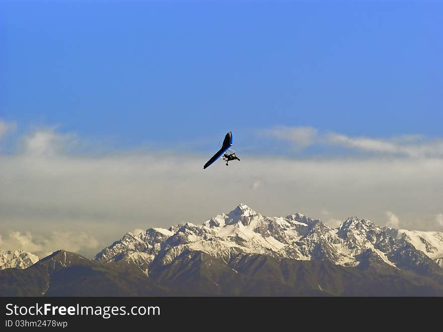 Powered hang glider mountains in the background.