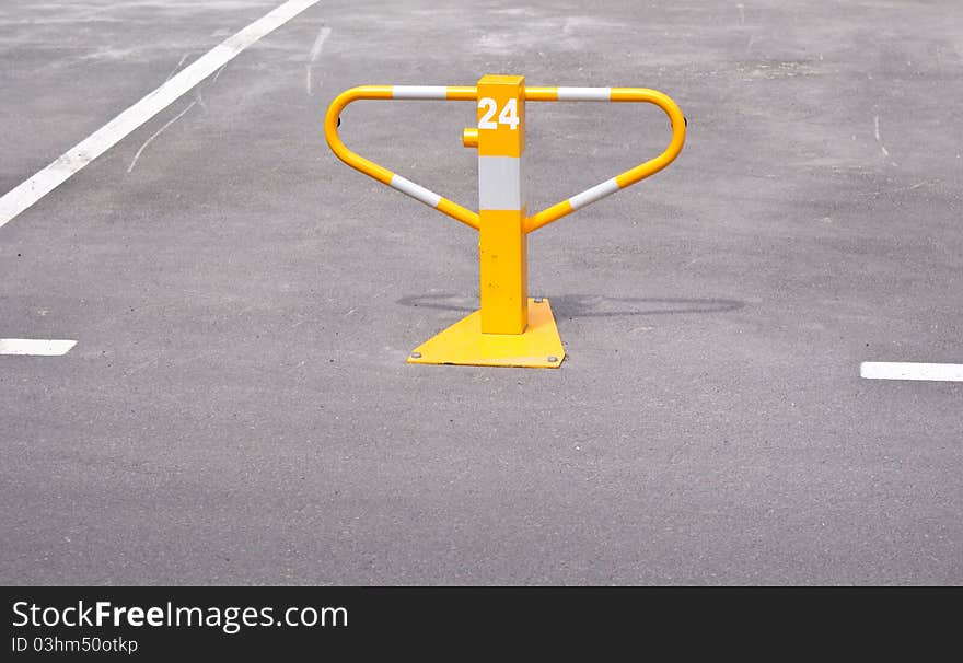 Empty parking lots with white lines and yellow bollard