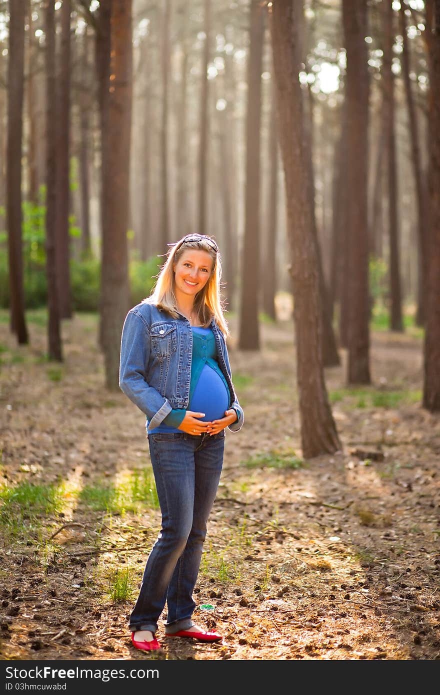 Pregnant woman in the forrest