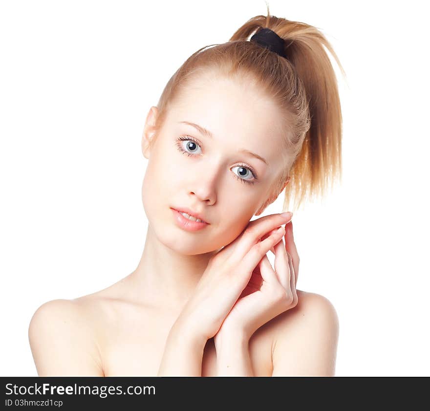 Beautiful blonde girl holding hands near the face, shot on a white background. Beautiful blonde girl holding hands near the face, shot on a white background