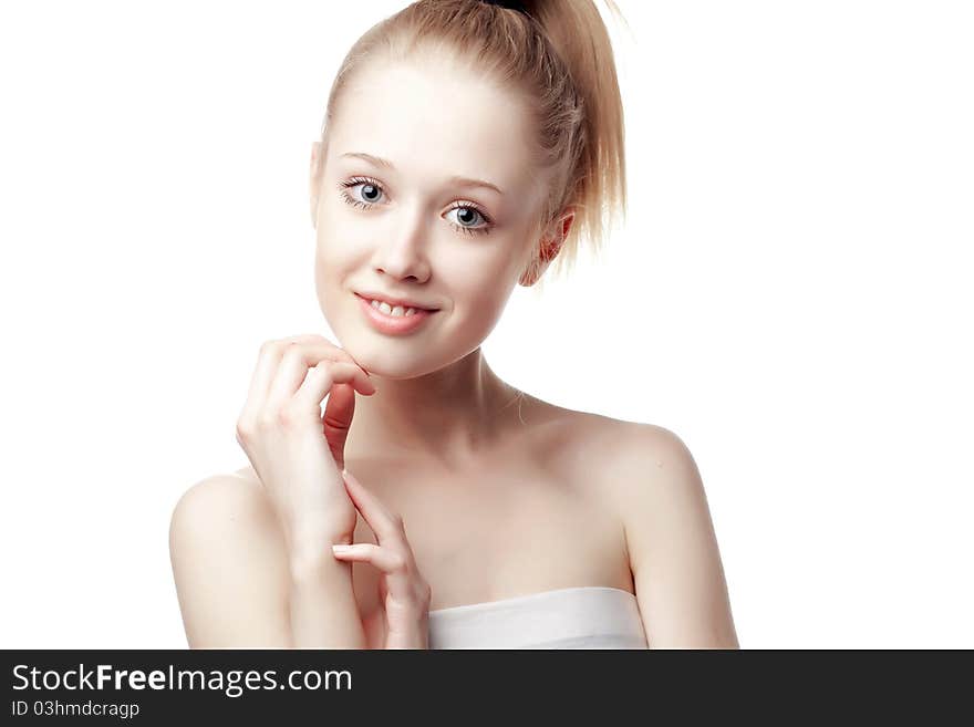 Beautiful blonde girl holding hands near the face, shot on a white background. Beautiful blonde girl holding hands near the face, shot on a white background