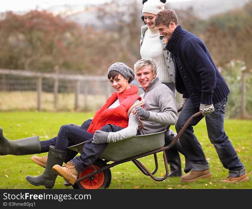 Two young couples playing in wheelbarrow