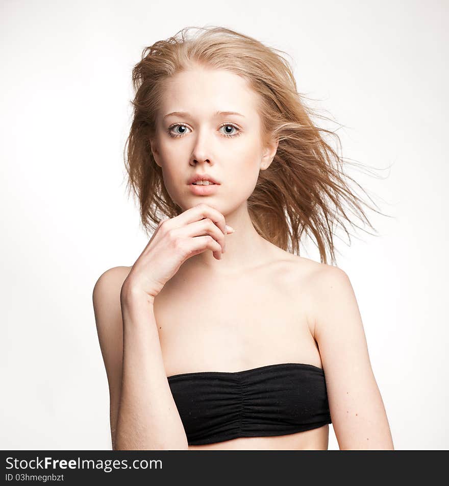 Beautiful blonde girl on a white background