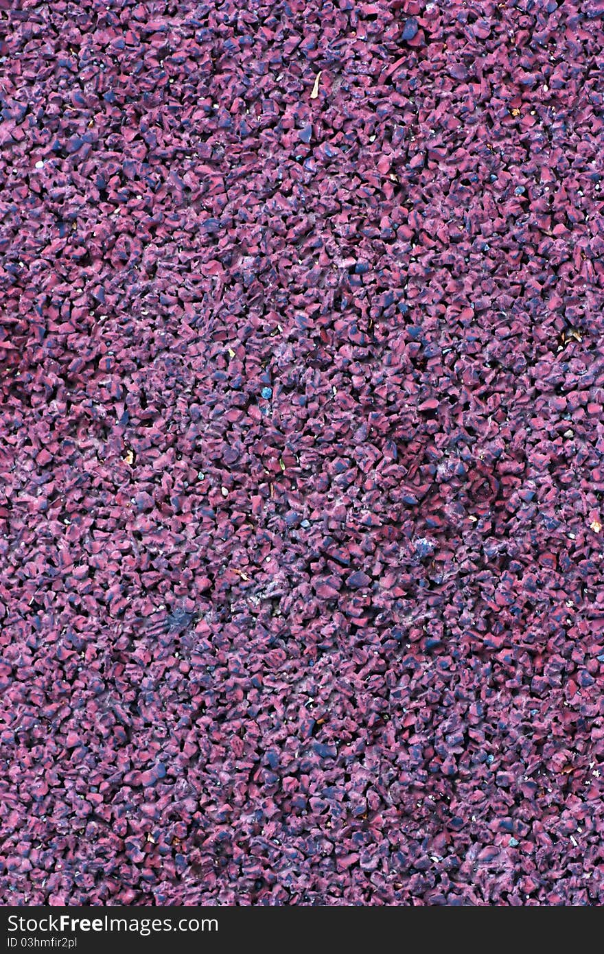 Rubber surface of sports ground. Red background.