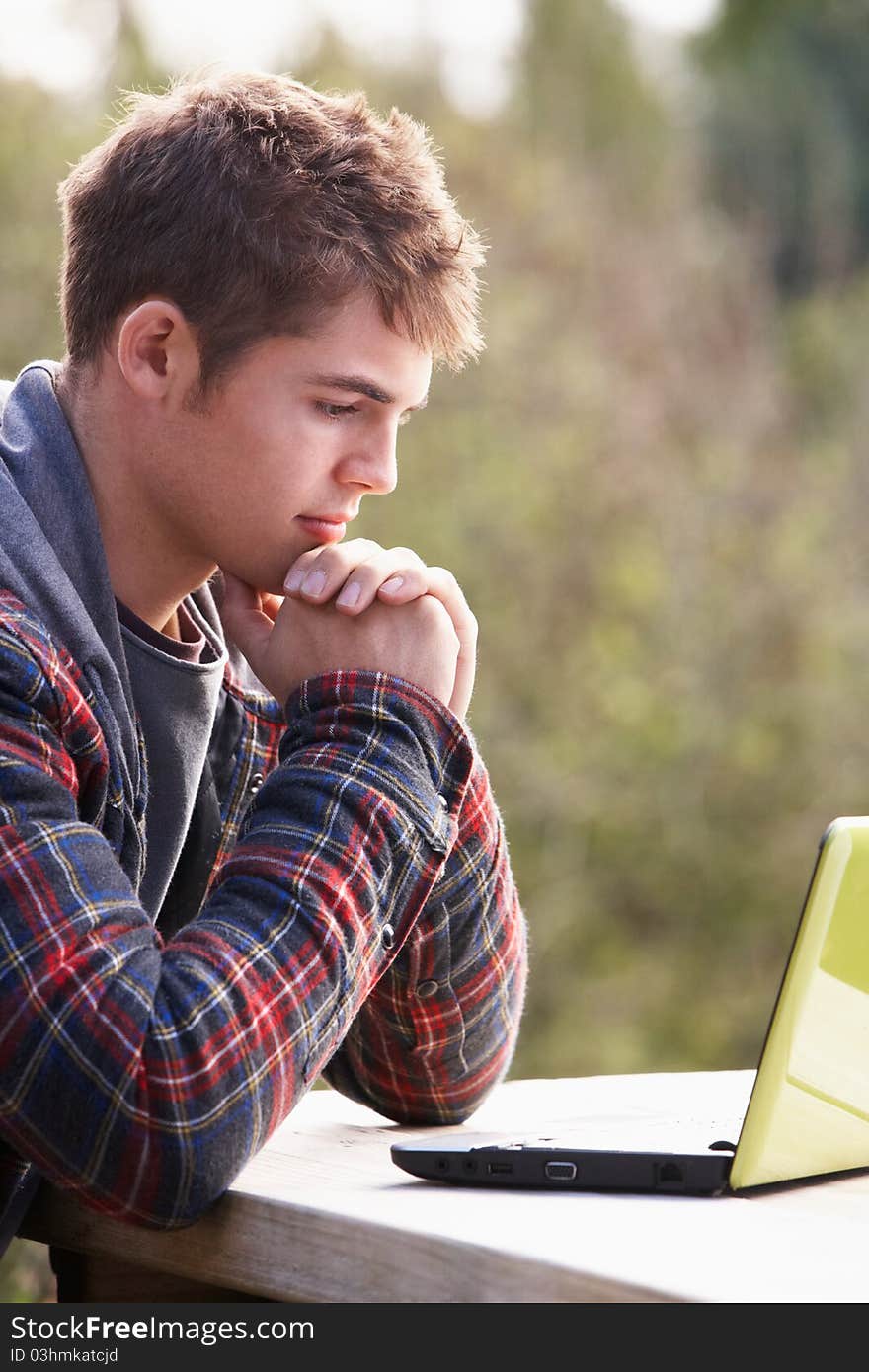 Young man with laptop computer concentrating