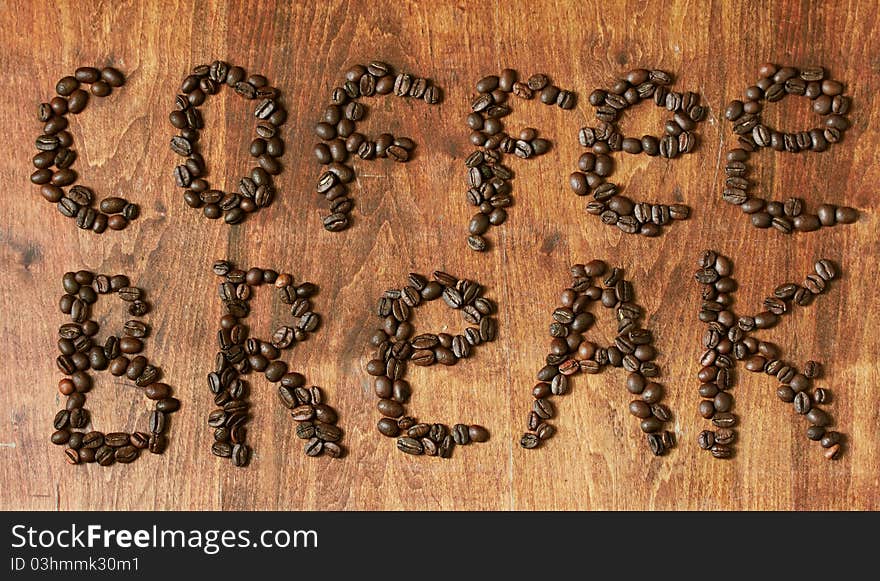 Coffee beans on wooden table, coffee break