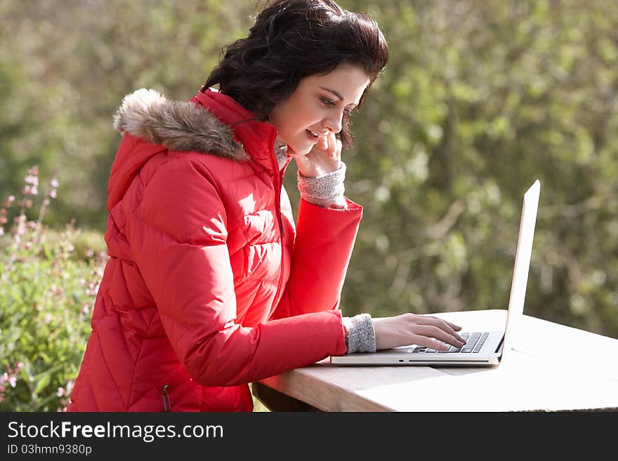 Young woman with laptop computer concentrating