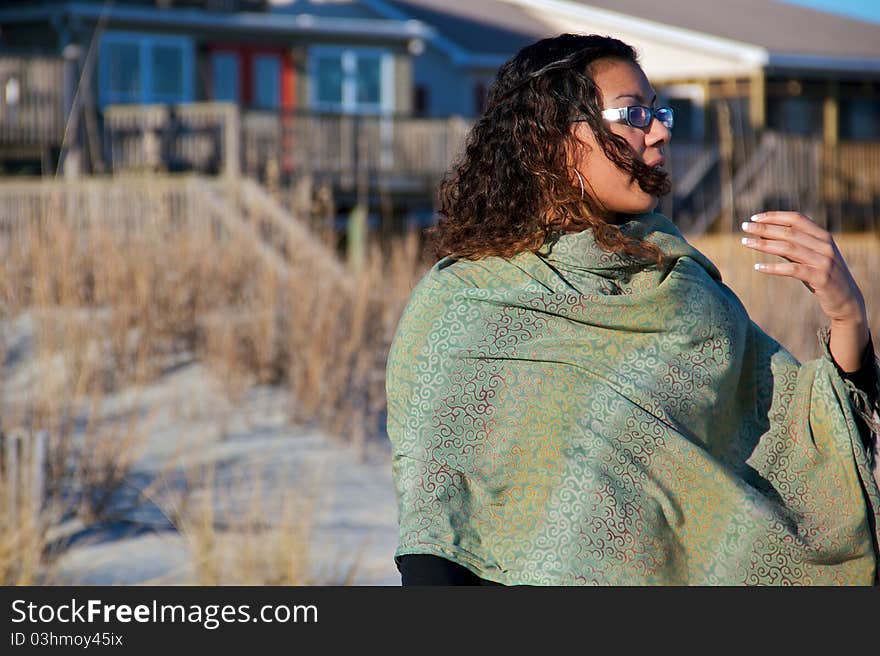 A women staring off into the ocean on a windy winter day. A women staring off into the ocean on a windy winter day