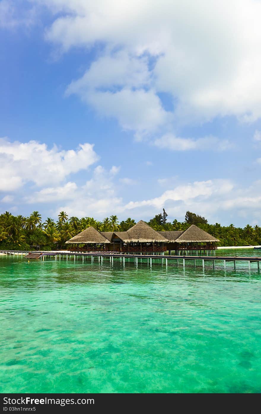 Water cafe on a tropical beach - Maldives travel background. Water cafe on a tropical beach - Maldives travel background