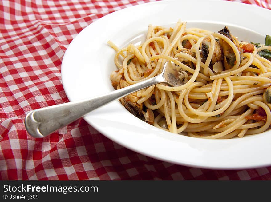 Freshly made spaghetti with a tomato and seafood souse that will taste fantastic on a summers day. Freshly made spaghetti with a tomato and seafood souse that will taste fantastic on a summers day.