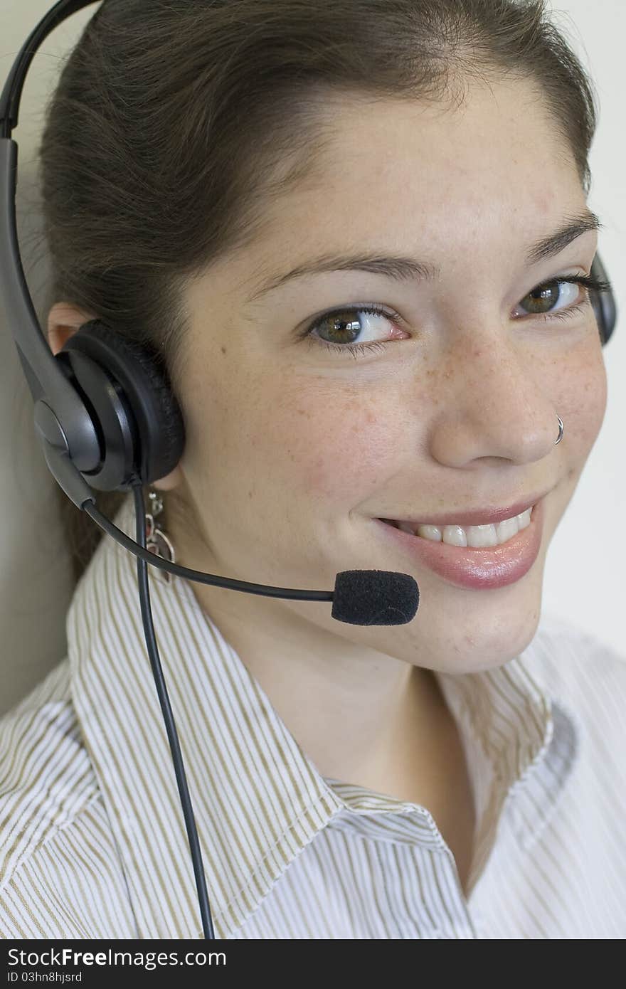 Young secretary with headset taking a call