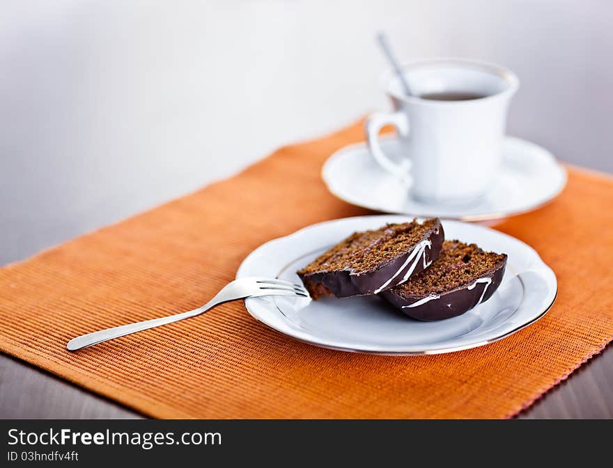 Slice of rich double chocolate cake and cup