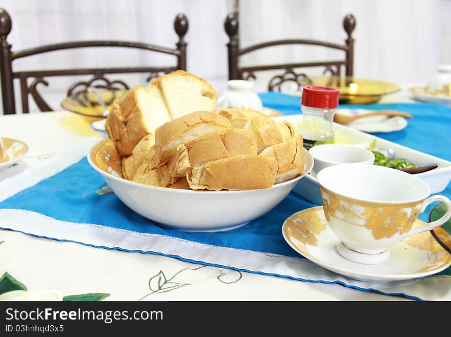 A table is prepared for breakfast with English bread served as the main food.