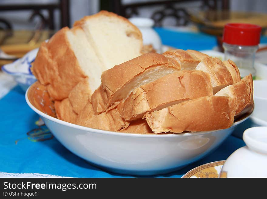 A table is prepared for breakfast with English bread served as the main food. A table is prepared for breakfast with English bread served as the main food.