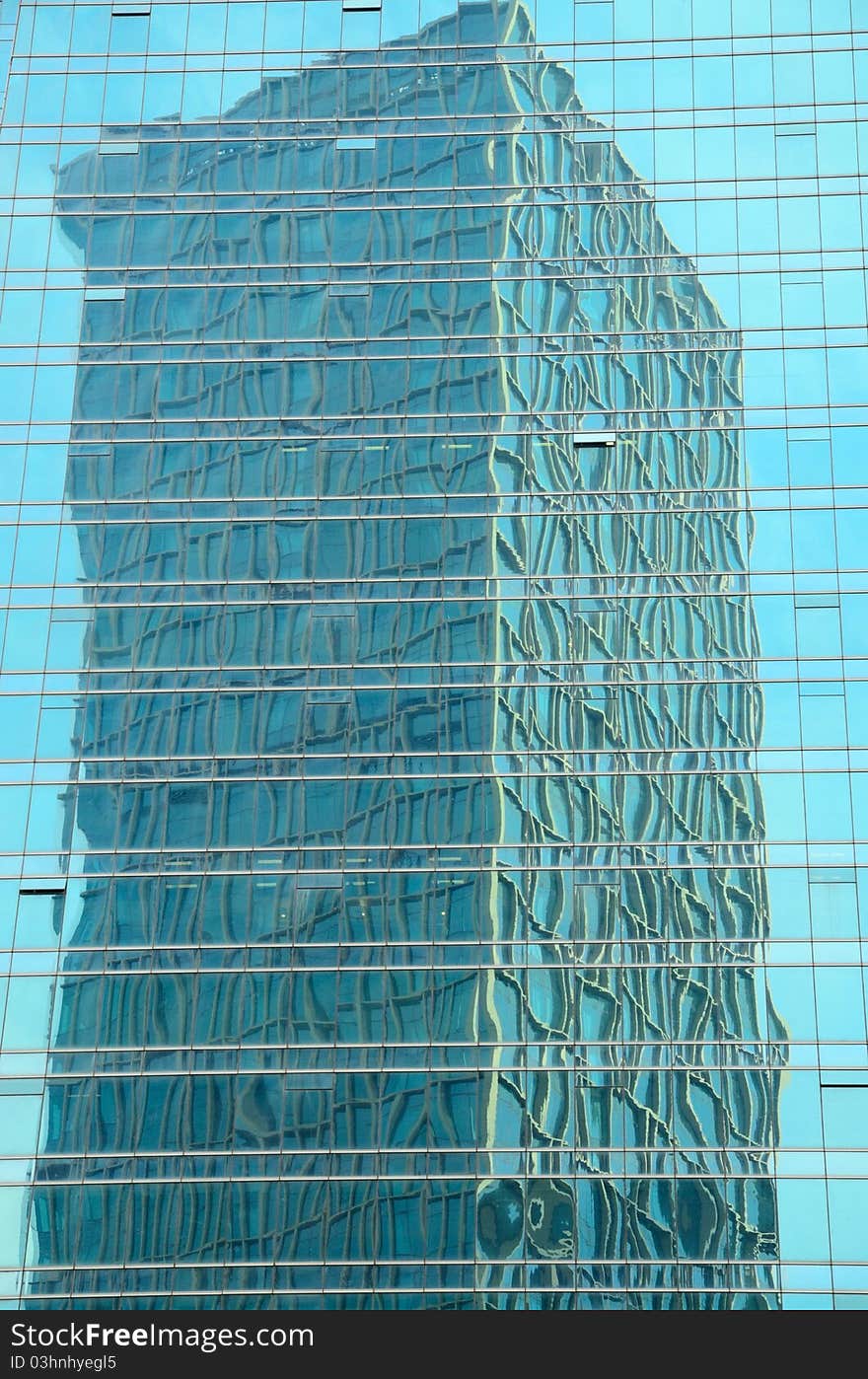 This was the exterior surface of a modern building. A tower was mirrored in another building. This was the exterior surface of a modern building. A tower was mirrored in another building.